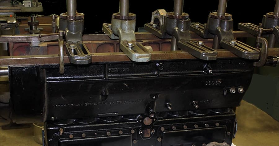 Antique engine block on the shop bench with valve assemblies installed